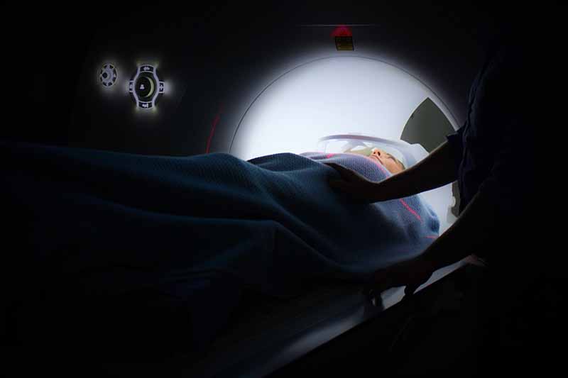 Picture of a lady gong into an MRI medical scanner