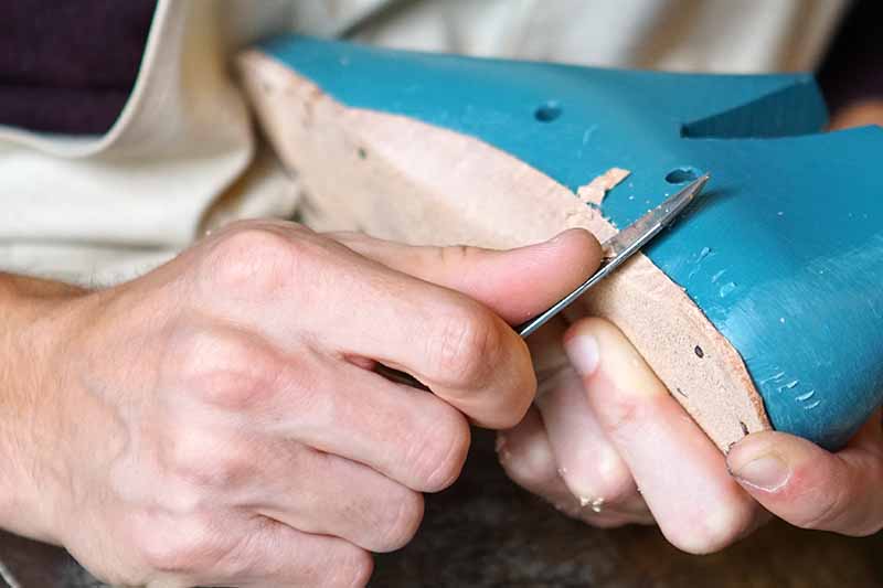 Picture of a mans hands making shoes