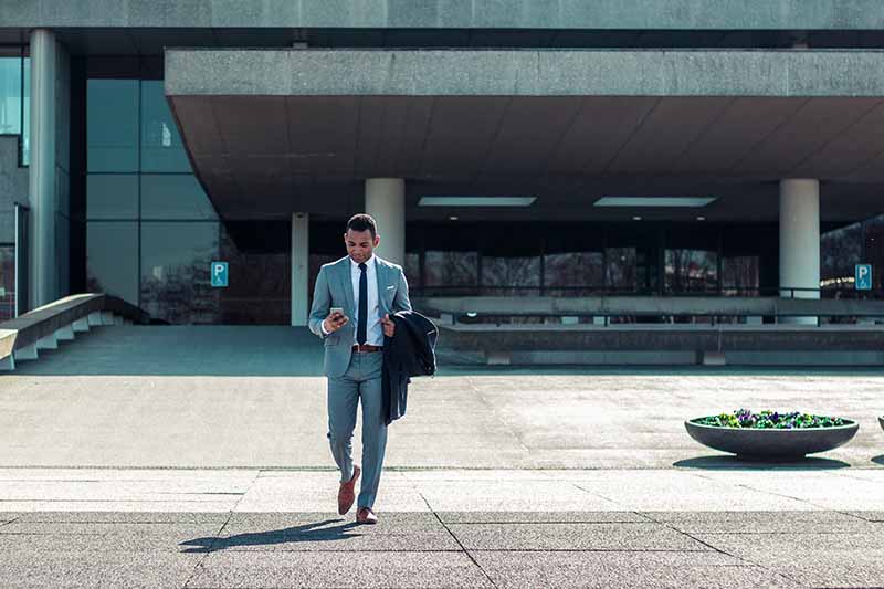 Picture of a man ina suit leaving a court building